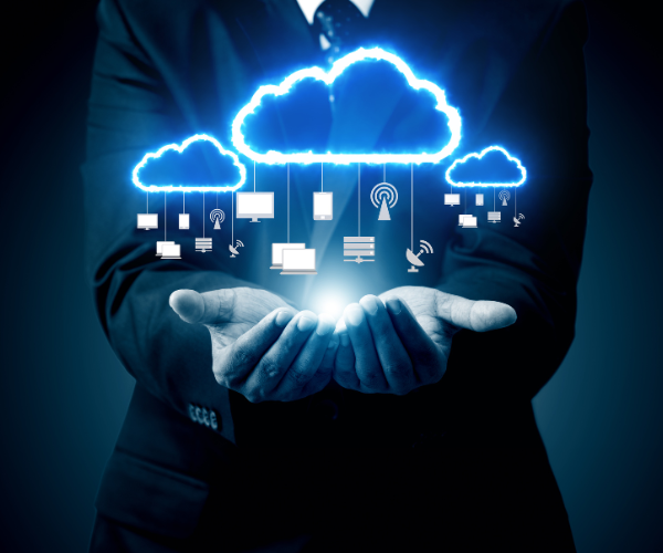 Businessman holding cloud computing icons in his hands, symbolizing digital technology and innovation in a corporate setting.